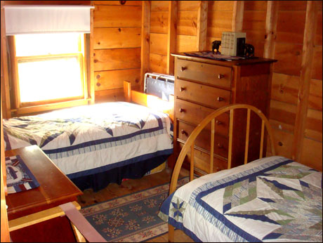 The second bedroom is furnished with twin beds